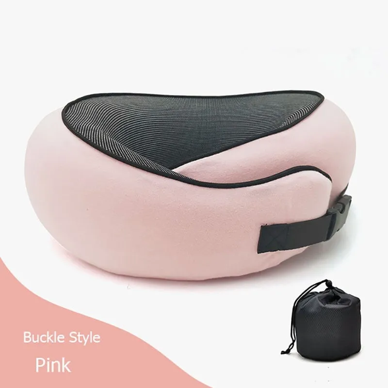 Navy blue U-shaped memory foam travel neck pillow rolled up next to its carry bag.