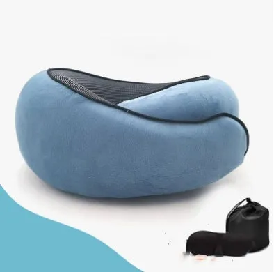 Navy blue U-shaped memory foam travel neck pillow rolled up next to its carry bag.