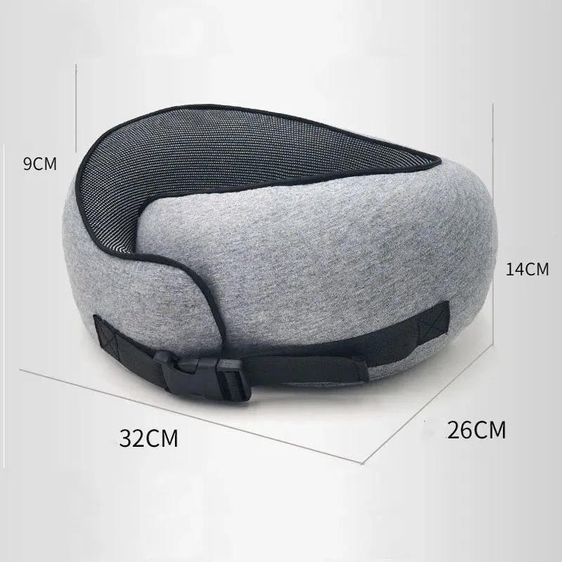 Navy blue U-shaped memory foam travel neck pillow rolled up next to its carry bag.