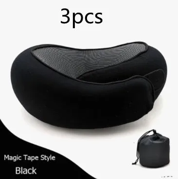 Navy blue U-shaped memory foam travel neck pillow rolled up next to its carry bag.