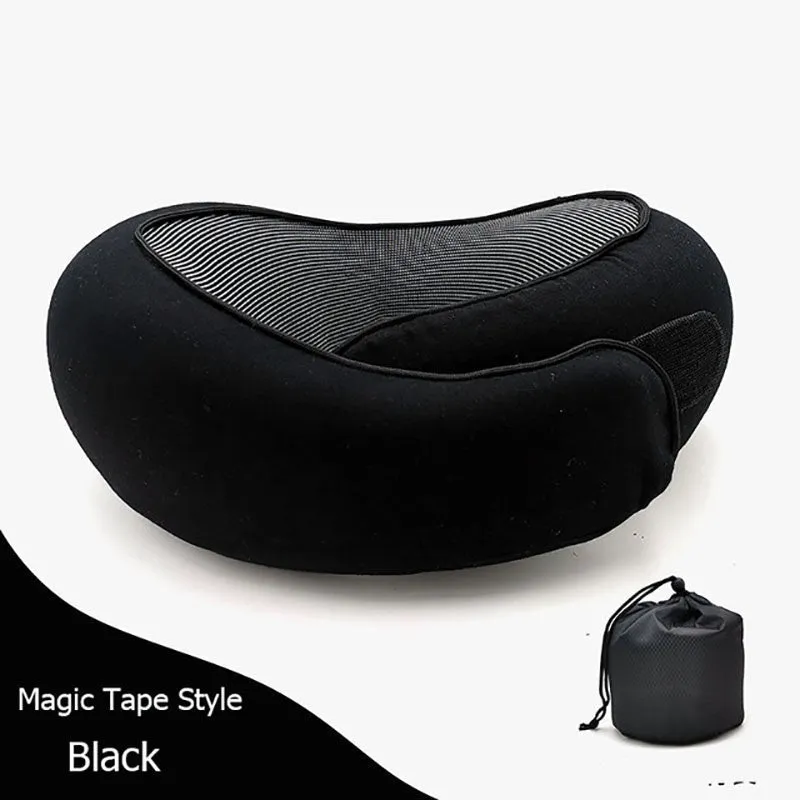 Navy blue U-shaped memory foam travel neck pillow rolled up next to its carry bag.