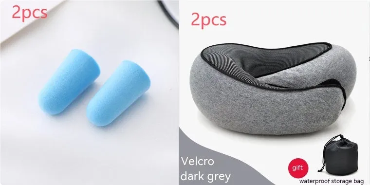 Navy blue U-shaped memory foam travel neck pillow rolled up next to its carry bag.