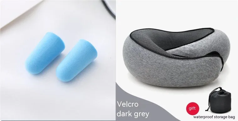 Navy blue U-shaped memory foam travel neck pillow rolled up next to its carry bag.