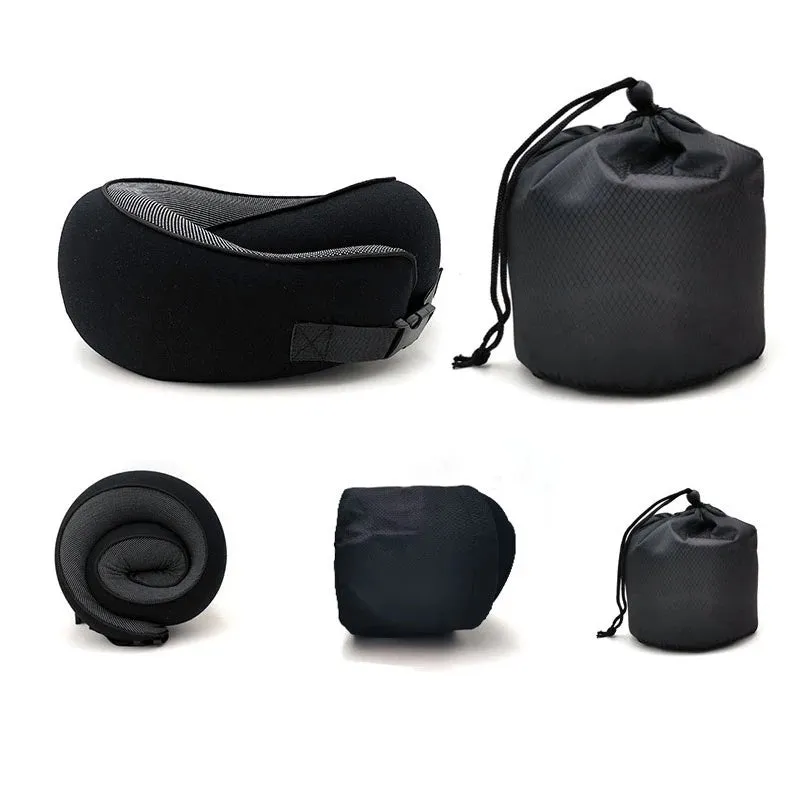 Navy blue U-shaped memory foam travel neck pillow rolled up next to its carry bag.