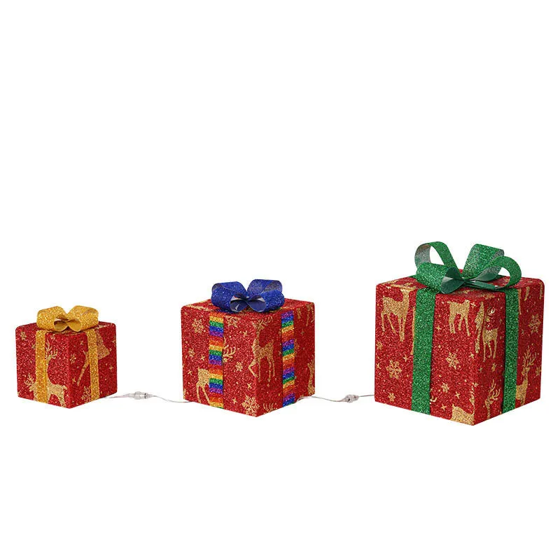 Set of three pre-lit Christmas gift box decorations with bows and LED lights for outdoor use.