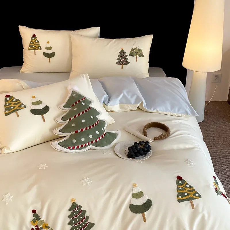 Cream blue duvet cover with raised towel embroidery of Christmas trees and flowers, part of a four-piece pure cotton bedding set.