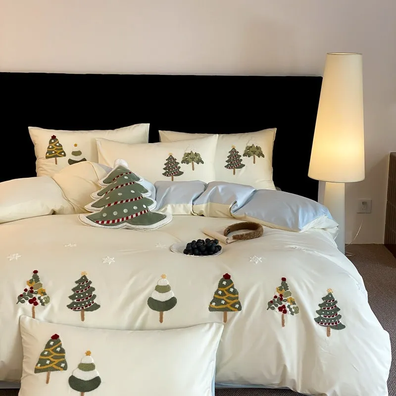 Cream blue duvet cover with raised towel embroidery of Christmas trees and flowers, part of a four-piece pure cotton bedding set.
