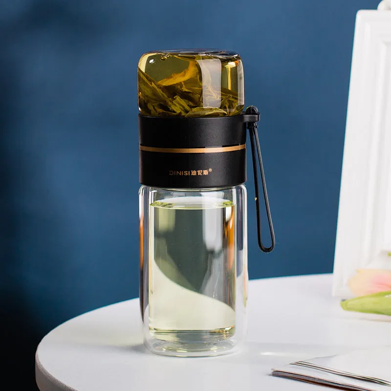 Green double-wall glass water bottle with a stainless steel tea infuser insert and a black leak-proof lid with rope handle.