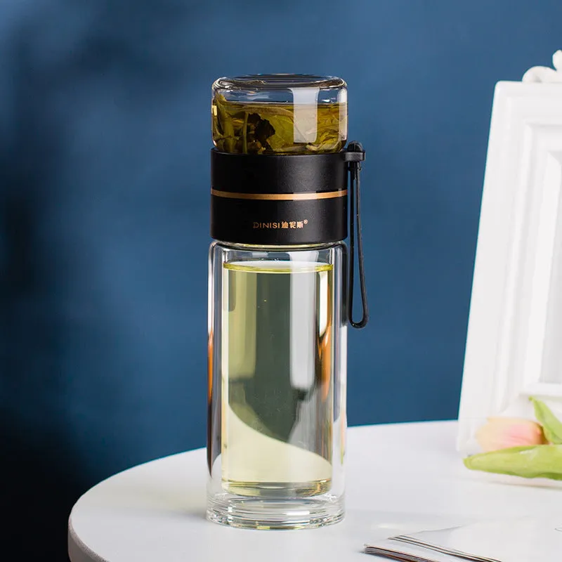 Green double-wall glass water bottle with a stainless steel tea infuser insert and a black leak-proof lid with rope handle.