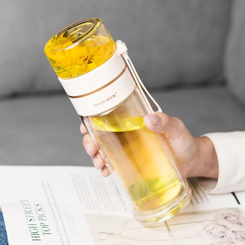 Green double-wall glass water bottle with a stainless steel tea infuser insert and a black leak-proof lid with rope handle.