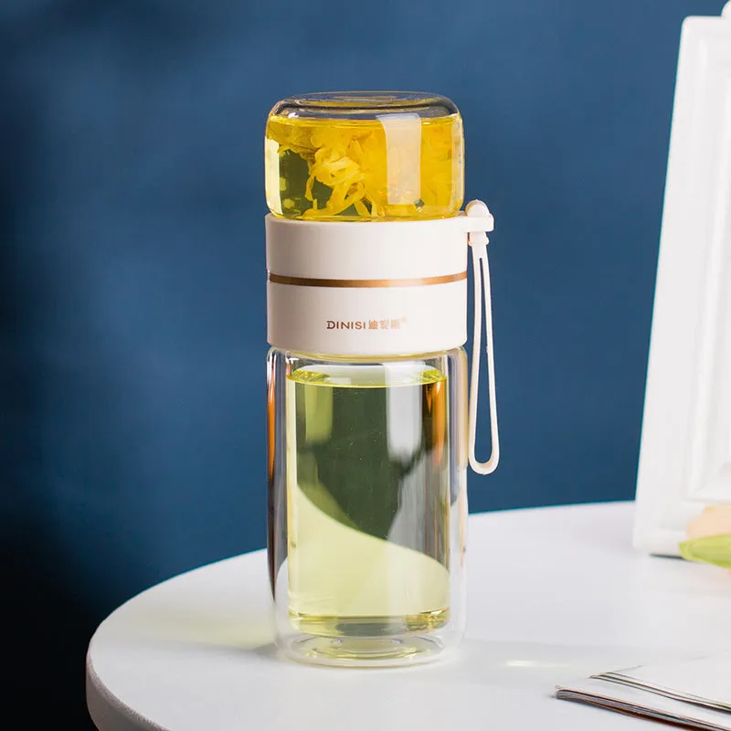 Green double-wall glass water bottle with a stainless steel tea infuser insert and a black leak-proof lid with rope handle.