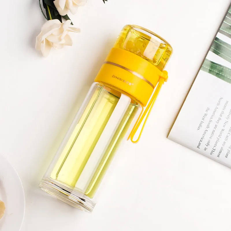 Green double-wall glass water bottle with a stainless steel tea infuser insert and a black leak-proof lid with rope handle.