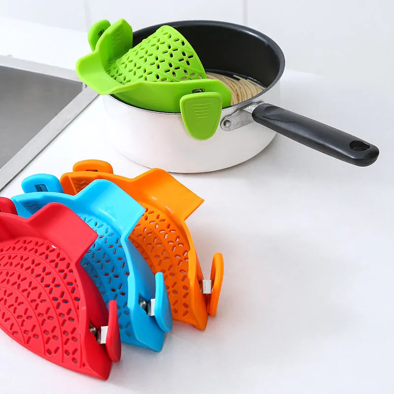 Silicone and stainless steel pot side drain stopper in multiple colours on a kitchen counter.