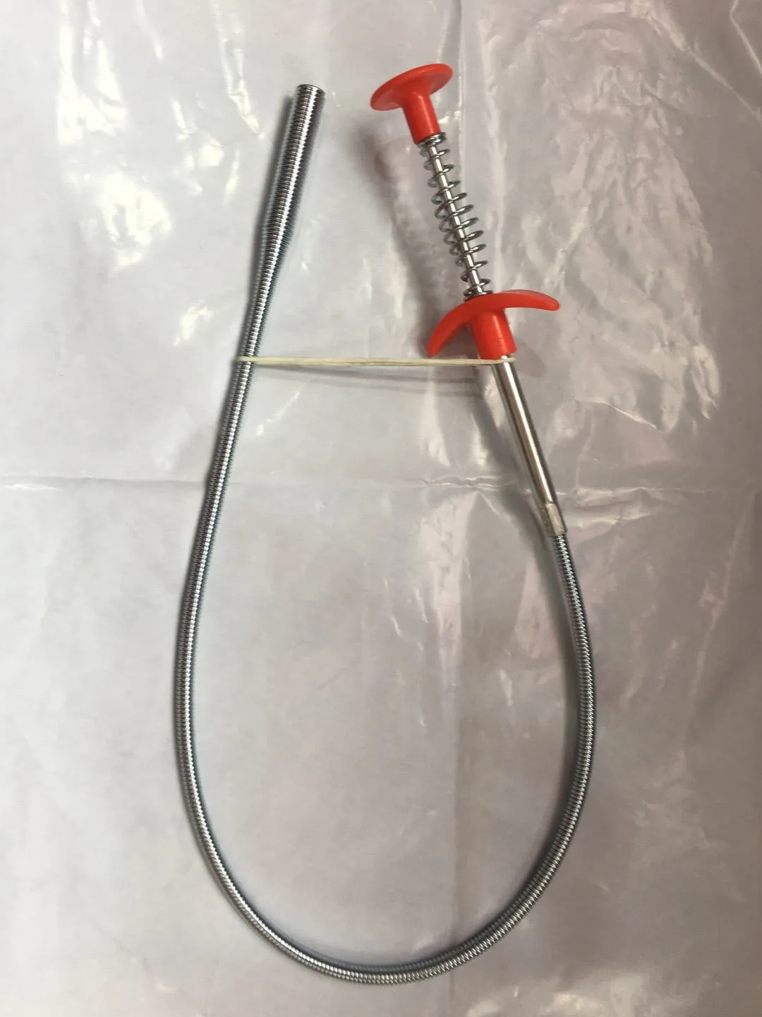Flexible 60cm long sewer dredger spring cleaning tool with a grip handle for unblocking sink drains.