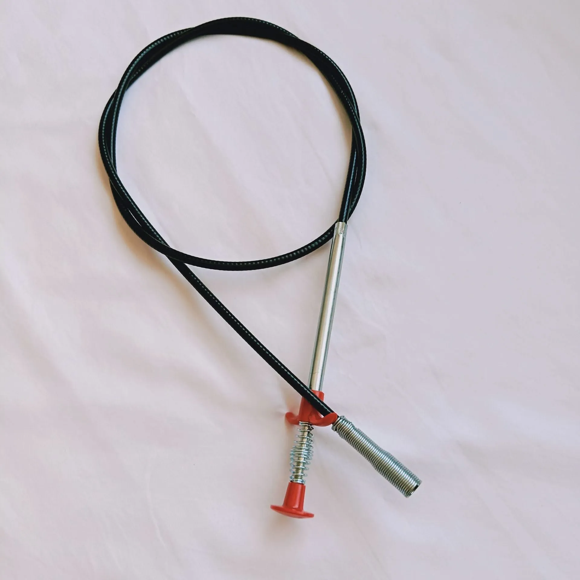 Flexible 60cm long sewer dredger spring cleaning tool with a grip handle for unblocking sink drains.