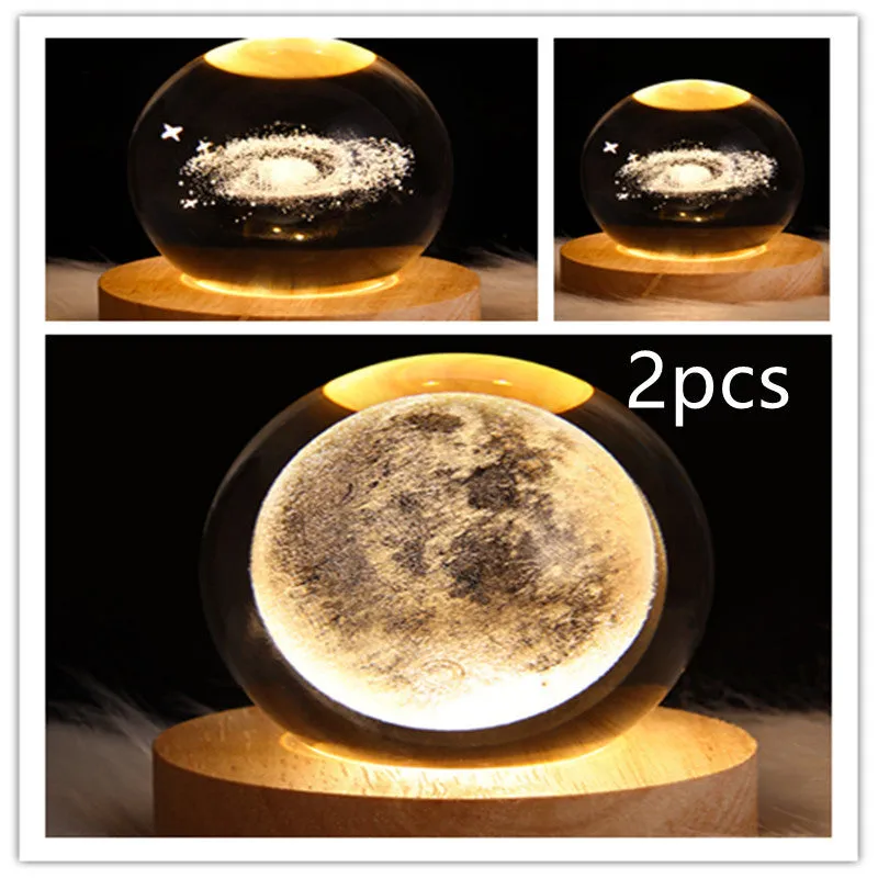 LED galaxy crystal ball night light with 3D planet designs on a table