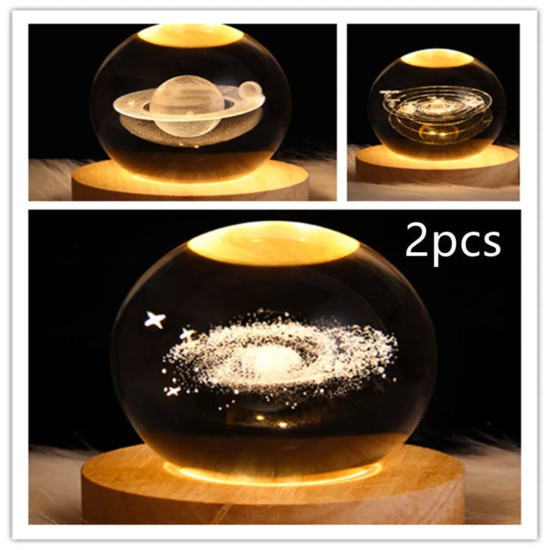 LED galaxy crystal ball night light with 3D planet designs on a table