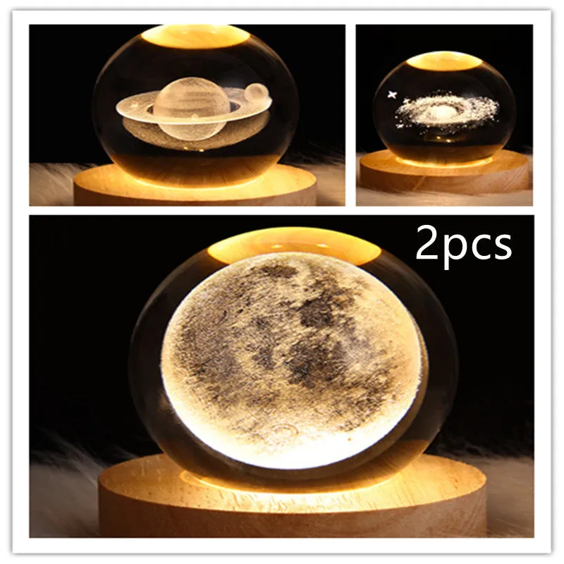 LED galaxy crystal ball night light with 3D planet designs on a table