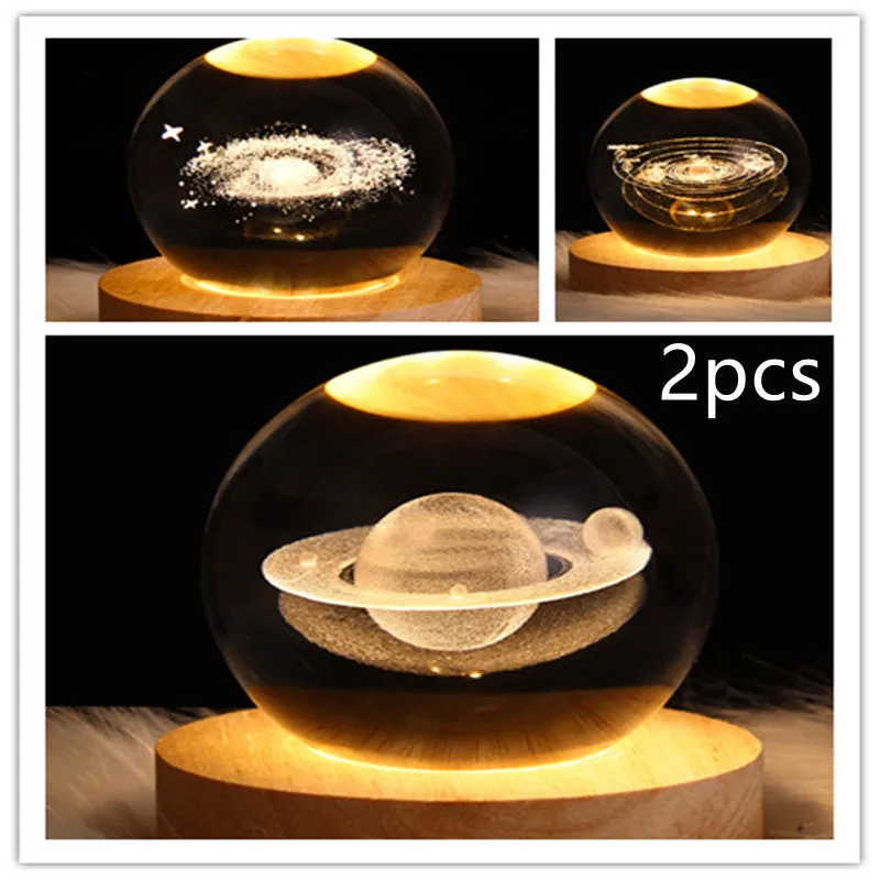 LED galaxy crystal ball night light with 3D planet designs on a table