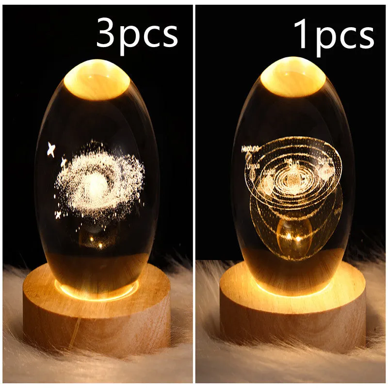 LED galaxy crystal ball night light with 3D planet designs on a table