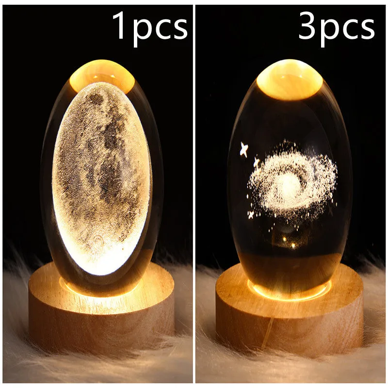 LED galaxy crystal ball night light with 3D planet designs on a table