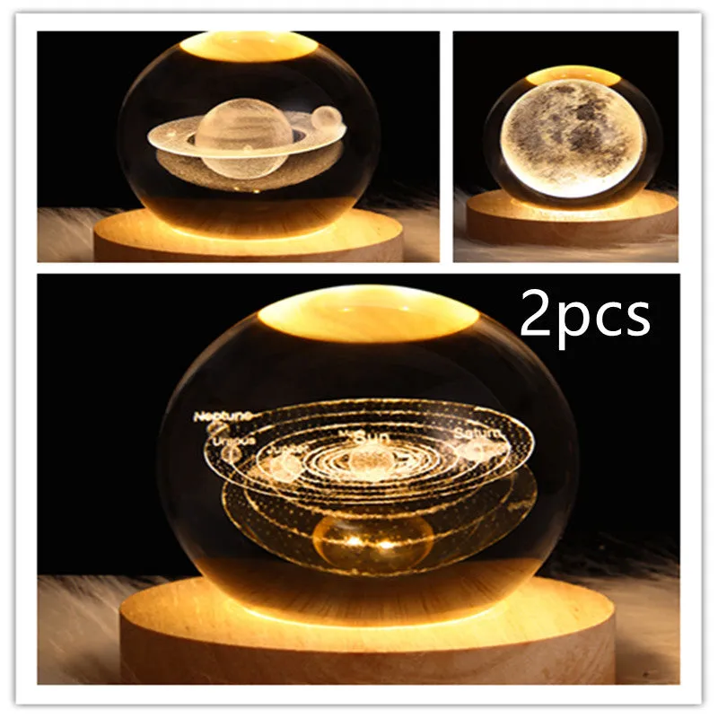 LED galaxy crystal ball night light with 3D planet designs on a table