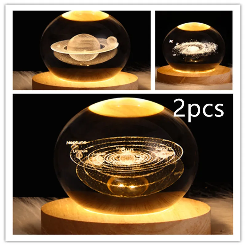 LED galaxy crystal ball night light with 3D planet designs on a table