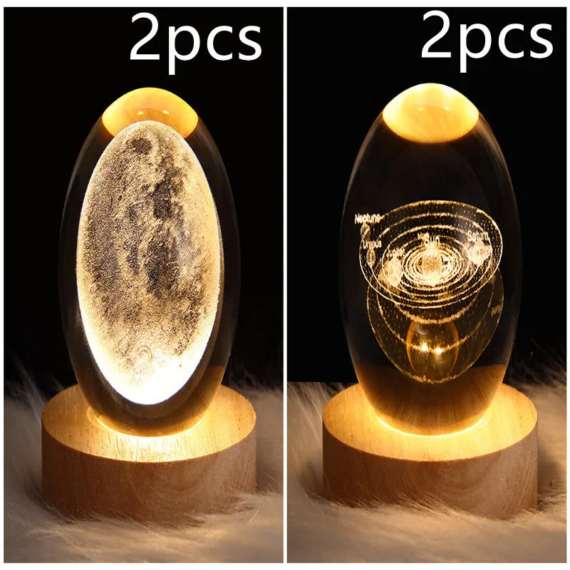 LED galaxy crystal ball night light with 3D planet designs on a table