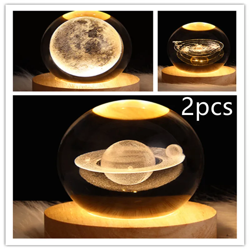 LED galaxy crystal ball night light with 3D planet designs on a table