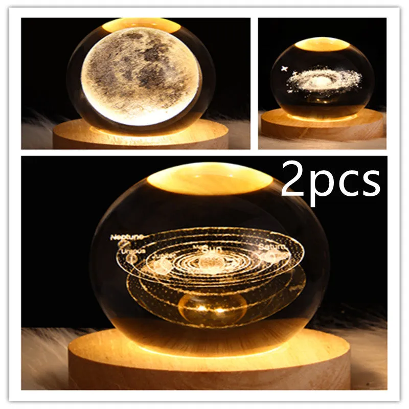 LED galaxy crystal ball night light with 3D planet designs on a table