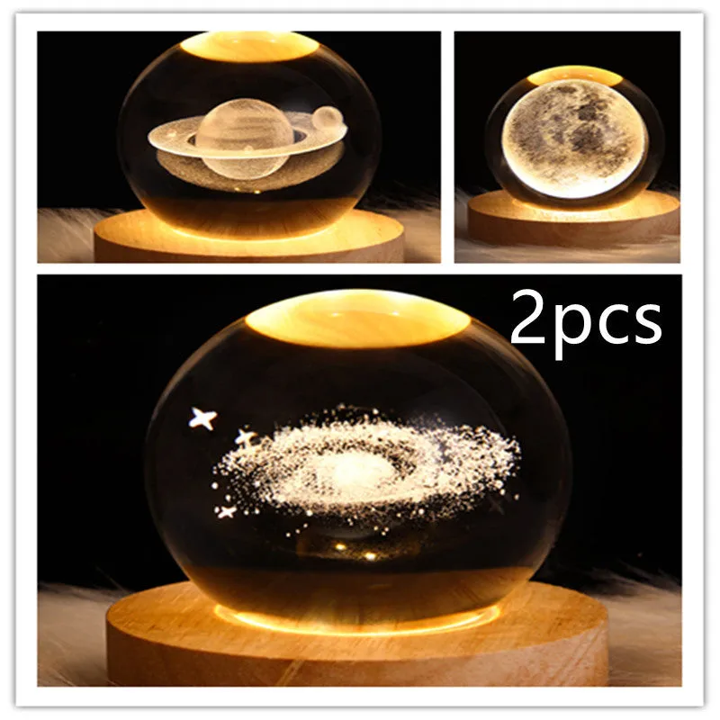 LED galaxy crystal ball night light with 3D planet designs on a table