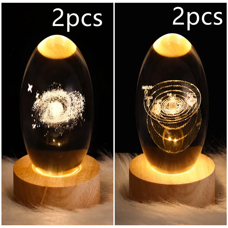 LED galaxy crystal ball night light with 3D planet designs on a table