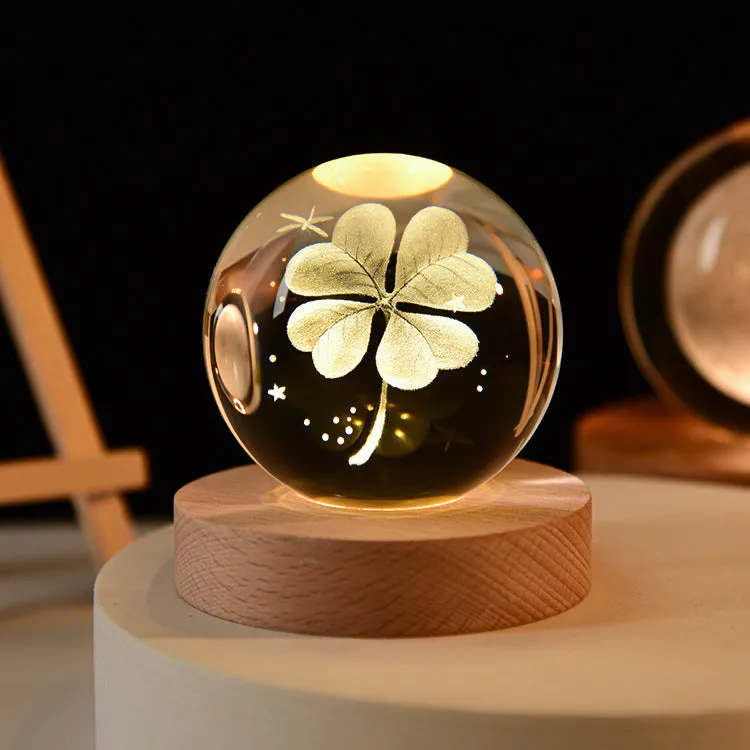 LED galaxy crystal ball night light with 3D planet designs on a table
