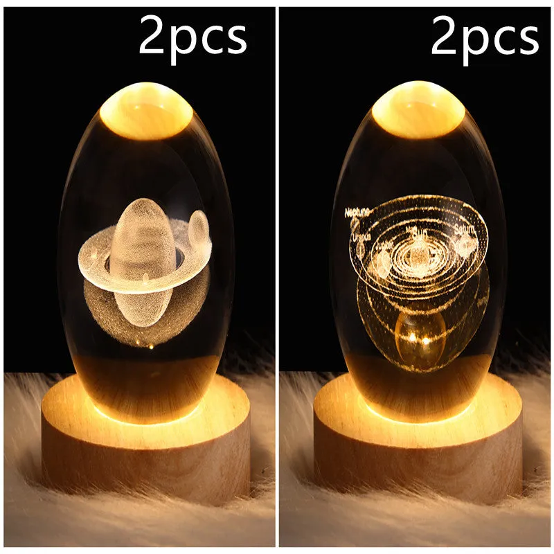 LED galaxy crystal ball night light with 3D planet designs on a table
