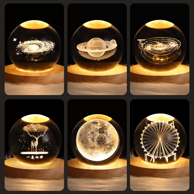 LED galaxy crystal ball night light with 3D planet designs on a table