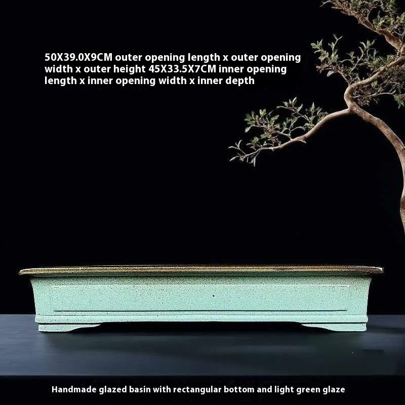 Green handmade ceramic bonsai flower pot with a purple sand crackled glaze finish.