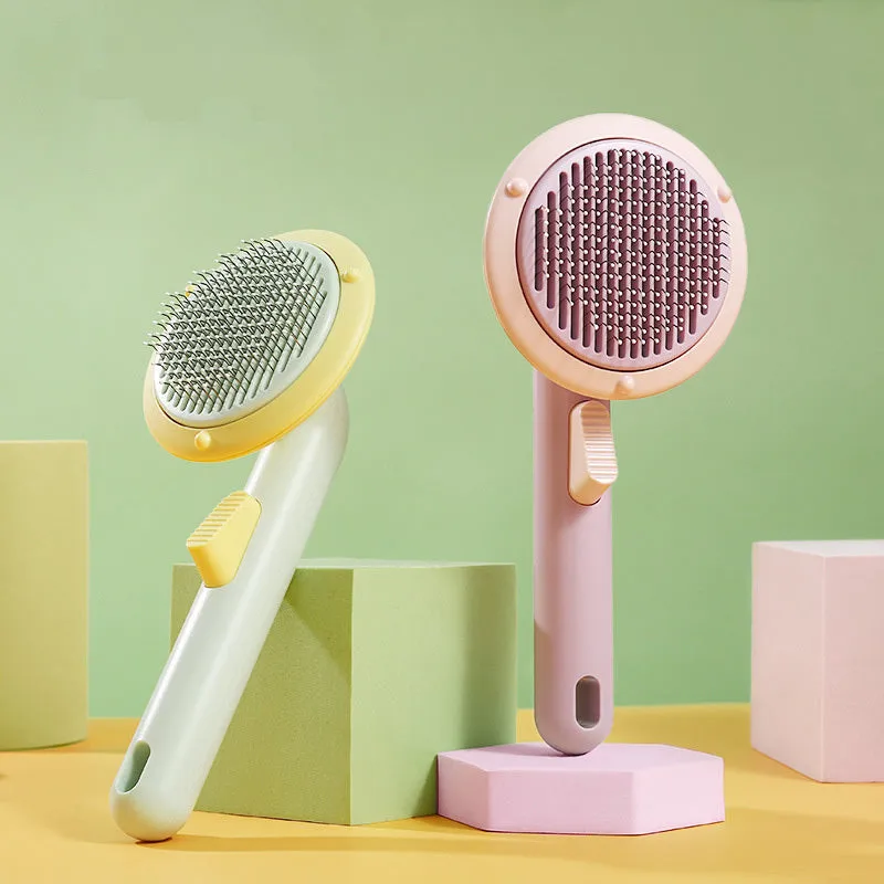 Hand-held pet grooming brush with curved stainless steel teeth in pumpkin colour option