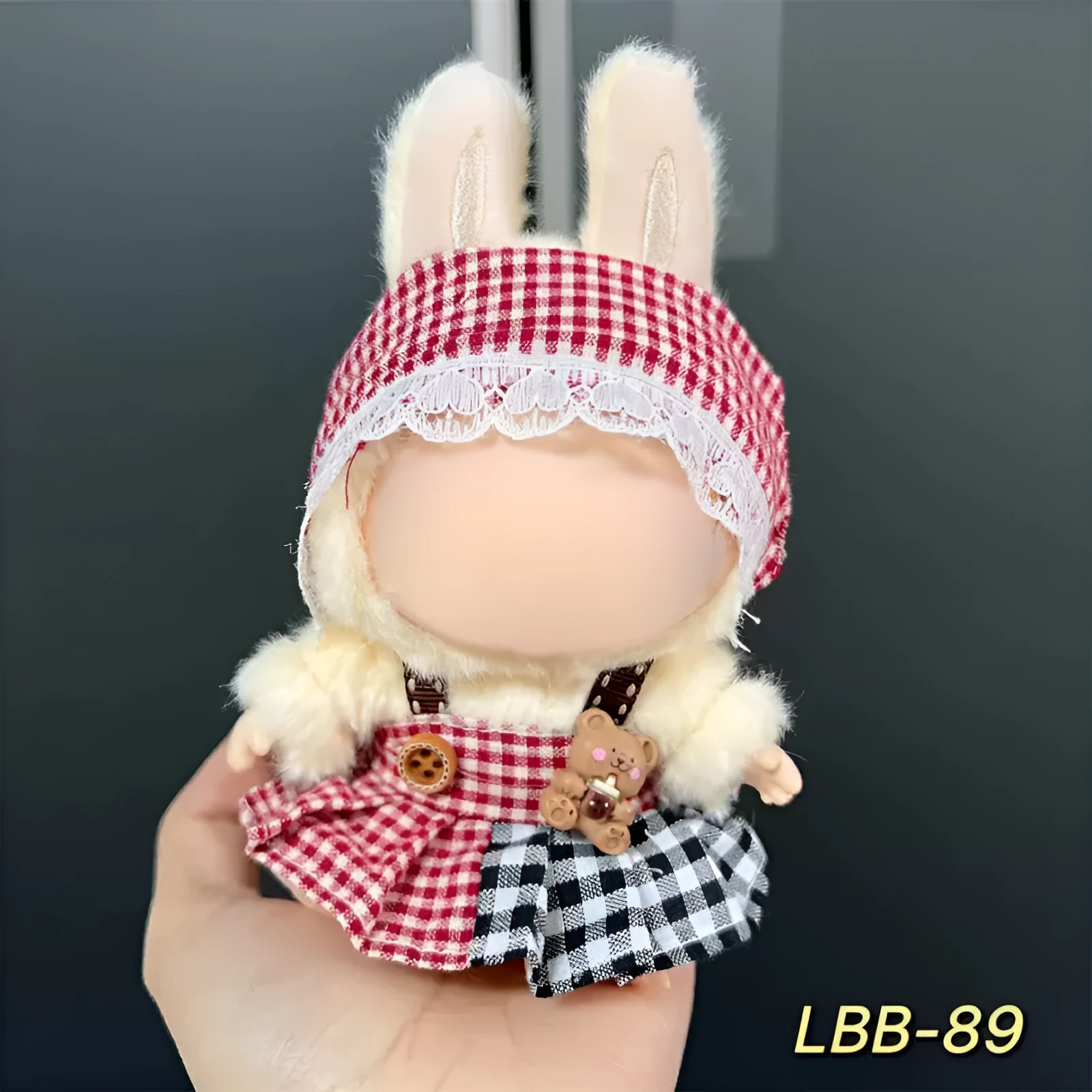 Plastic clothing costume for a 17cm tall vinyl doll figurine on display.