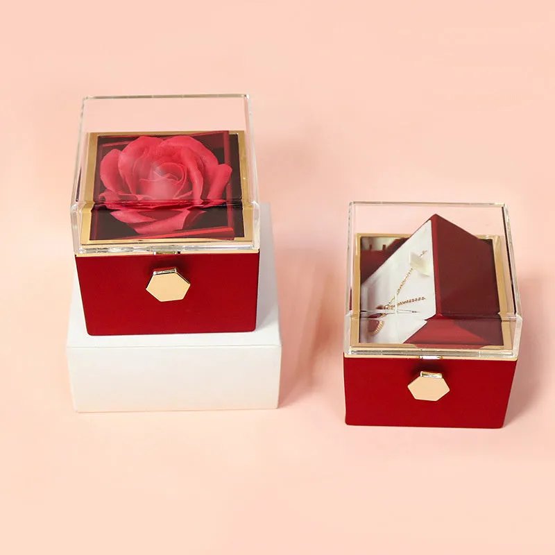 Rotating jewellery gift box with a preserved red rose under a clear acrylic dome.