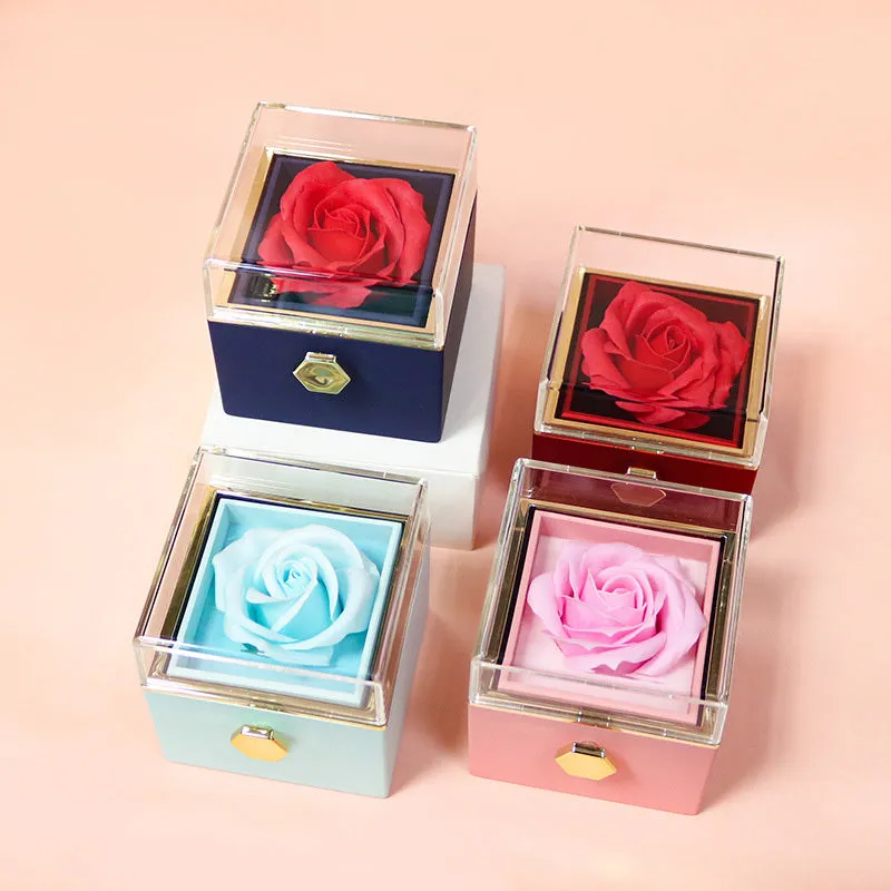 Rotating jewellery gift box with a preserved red rose under a clear acrylic dome.