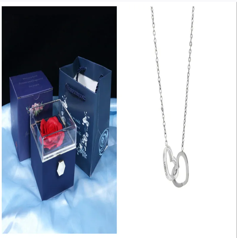 Rotating jewellery gift box with a preserved red rose under a clear acrylic dome.