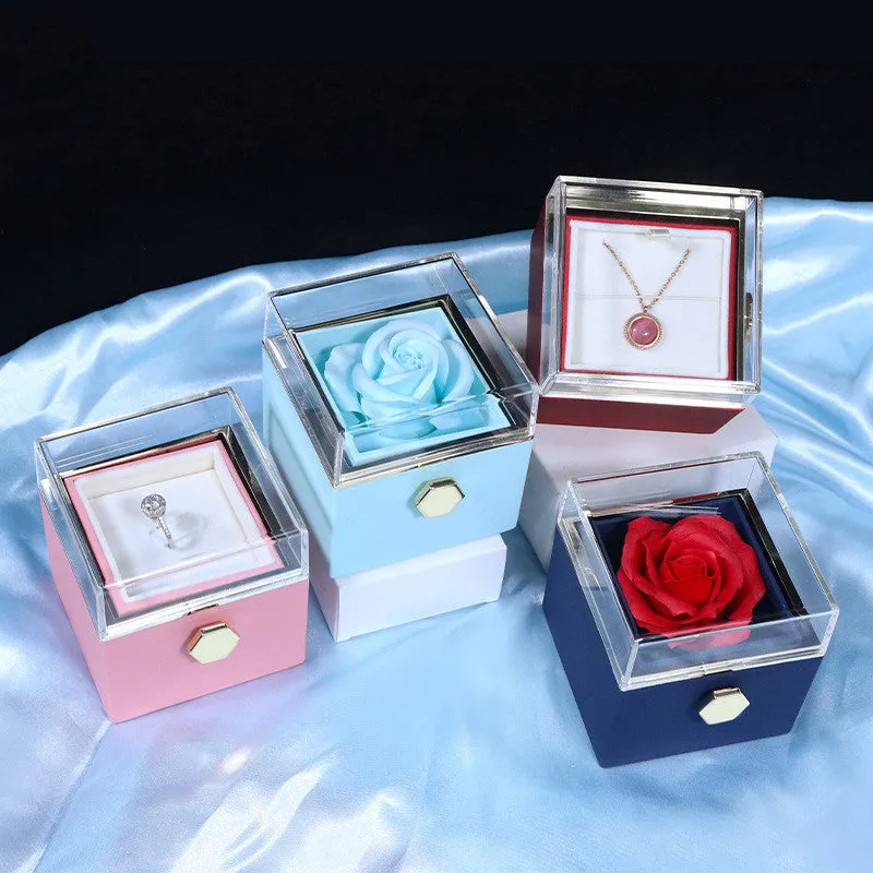 Rotating jewellery gift box with a preserved red rose under a clear acrylic dome.