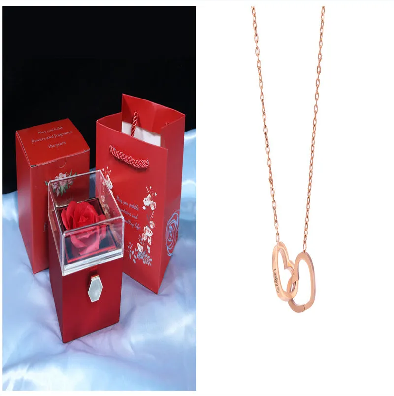 Rotating jewellery gift box with a preserved red rose under a clear acrylic dome.