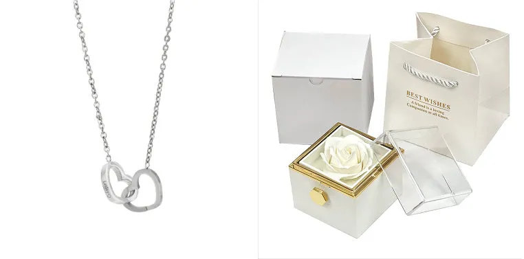 Rotating jewellery gift box with a preserved red rose under a clear acrylic dome.