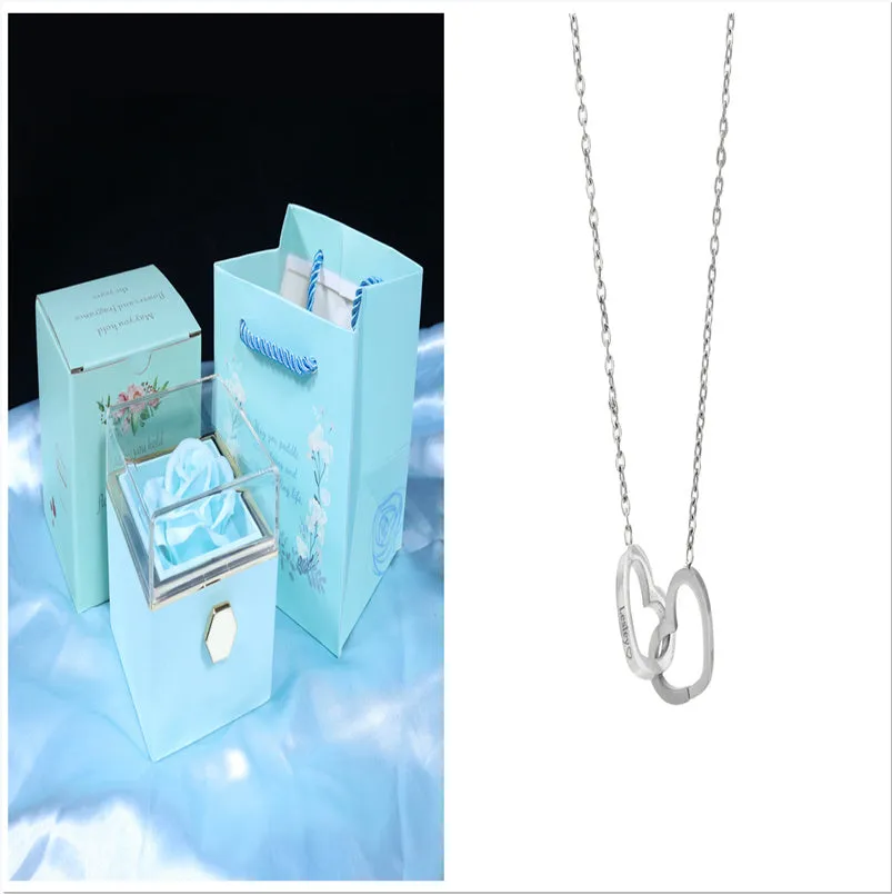 Rotating jewellery gift box with a preserved red rose under a clear acrylic dome.