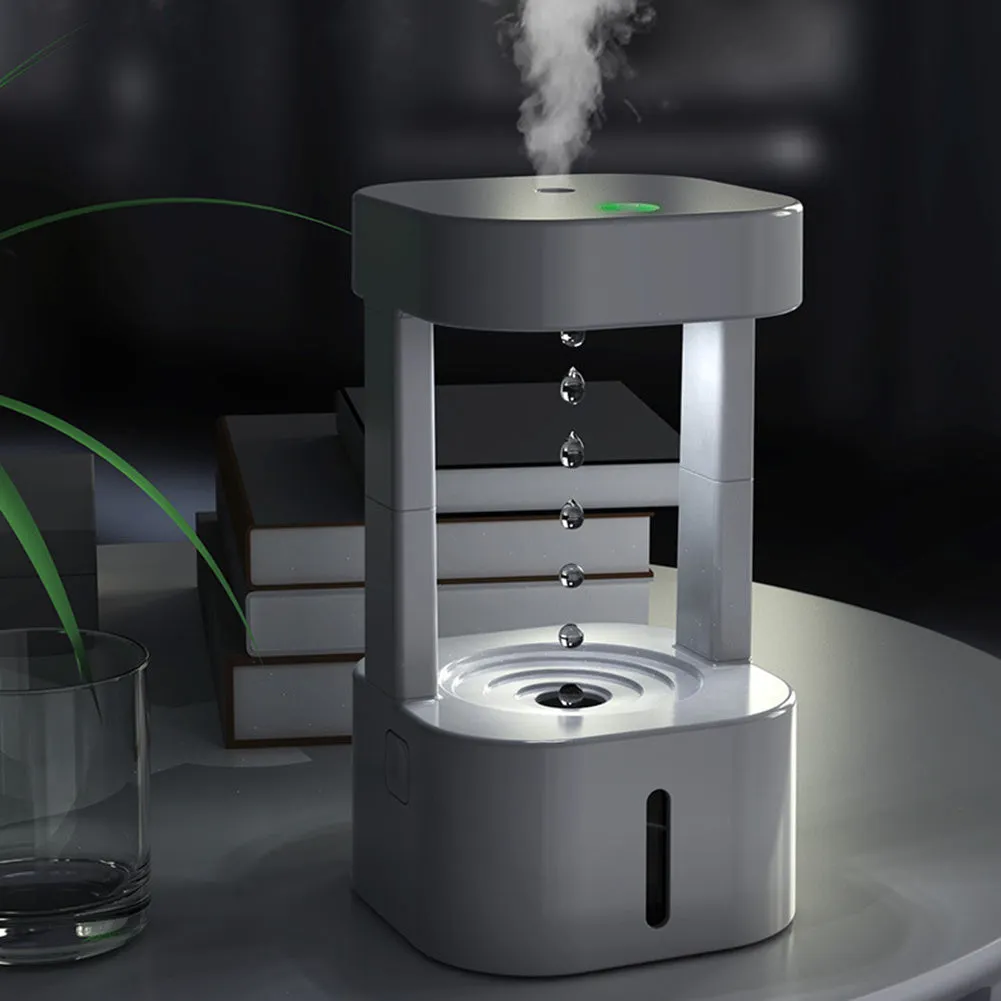 White anti-gravity water droplet USB humidifier with coloured lights on a desk