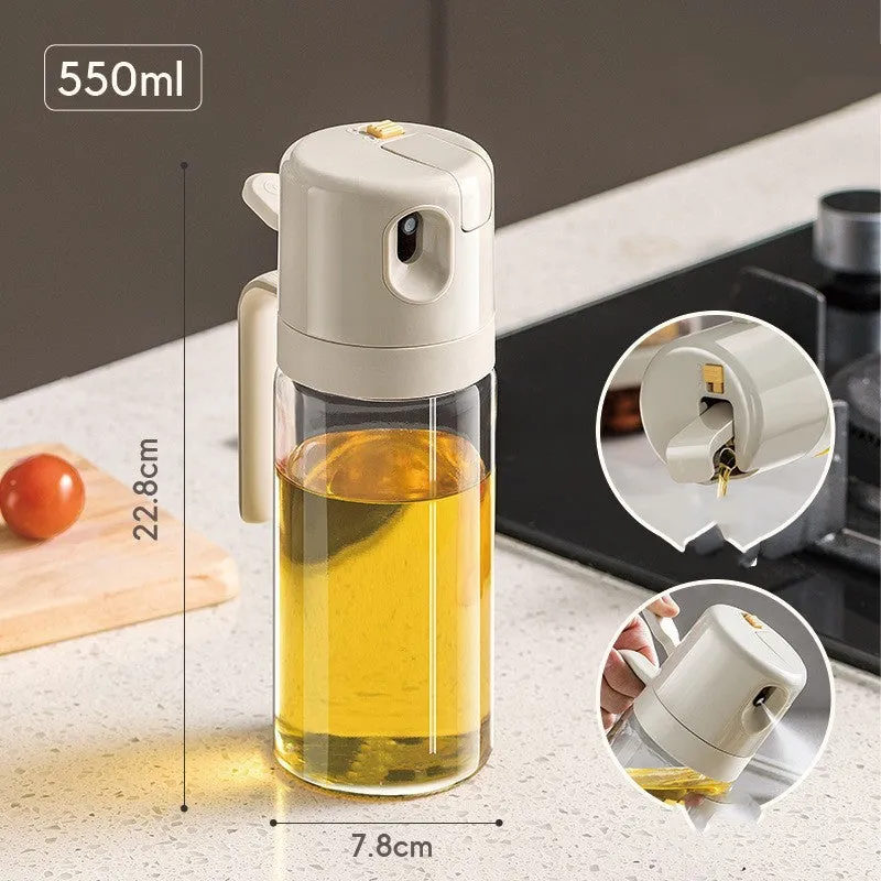 Warm grey glass 550ml oil sprayer bottle with a black spray head on a kitchen counter.