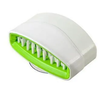 Blue kitchen cleaning brush with suction cup showing knife and fork design for washing fruits and vegetables