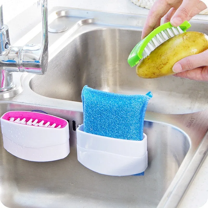 Blue kitchen cleaning brush with suction cup showing knife and fork design for washing fruits and vegetables