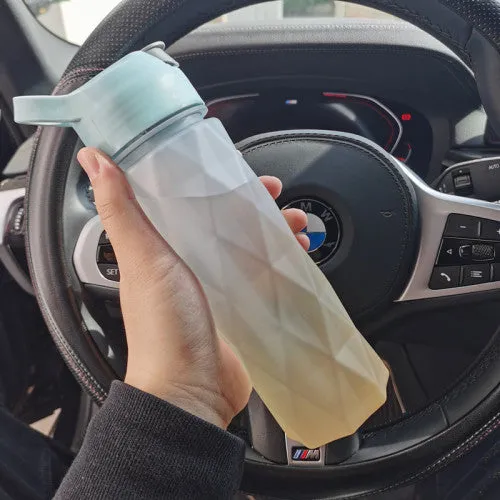 White 700ml plastic spray water bottle with handle strap and leakproof lid.